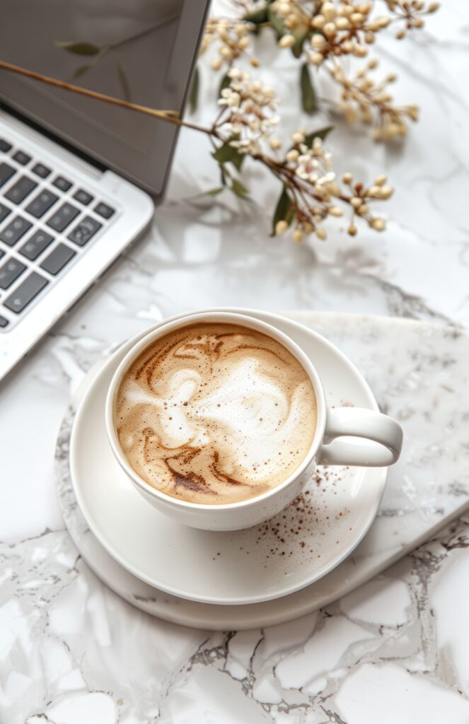 coffee on a white plate with laptop and mug
